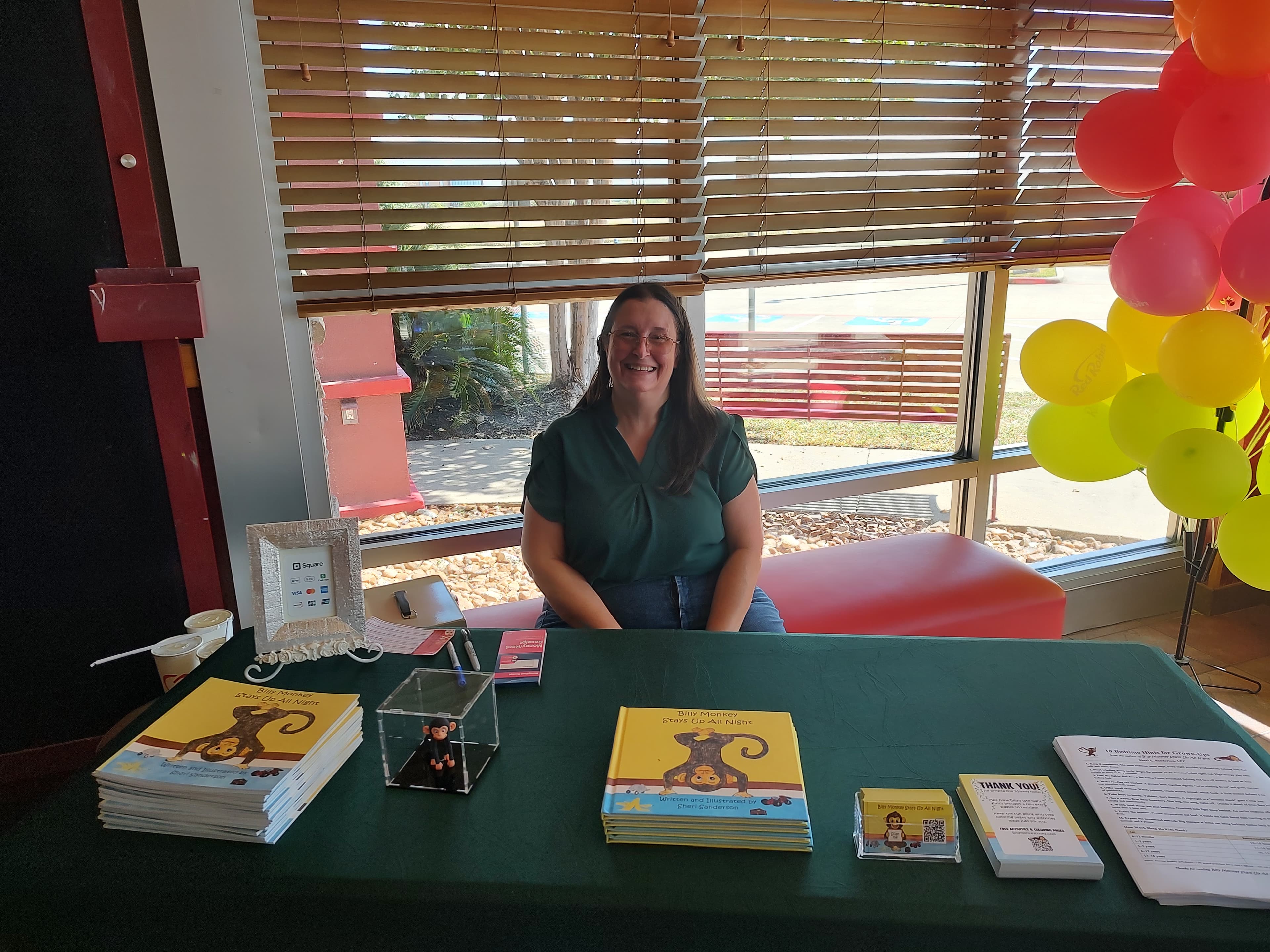Author Sheri Sanderson at her Billy Monkey book signing table at Red Robin