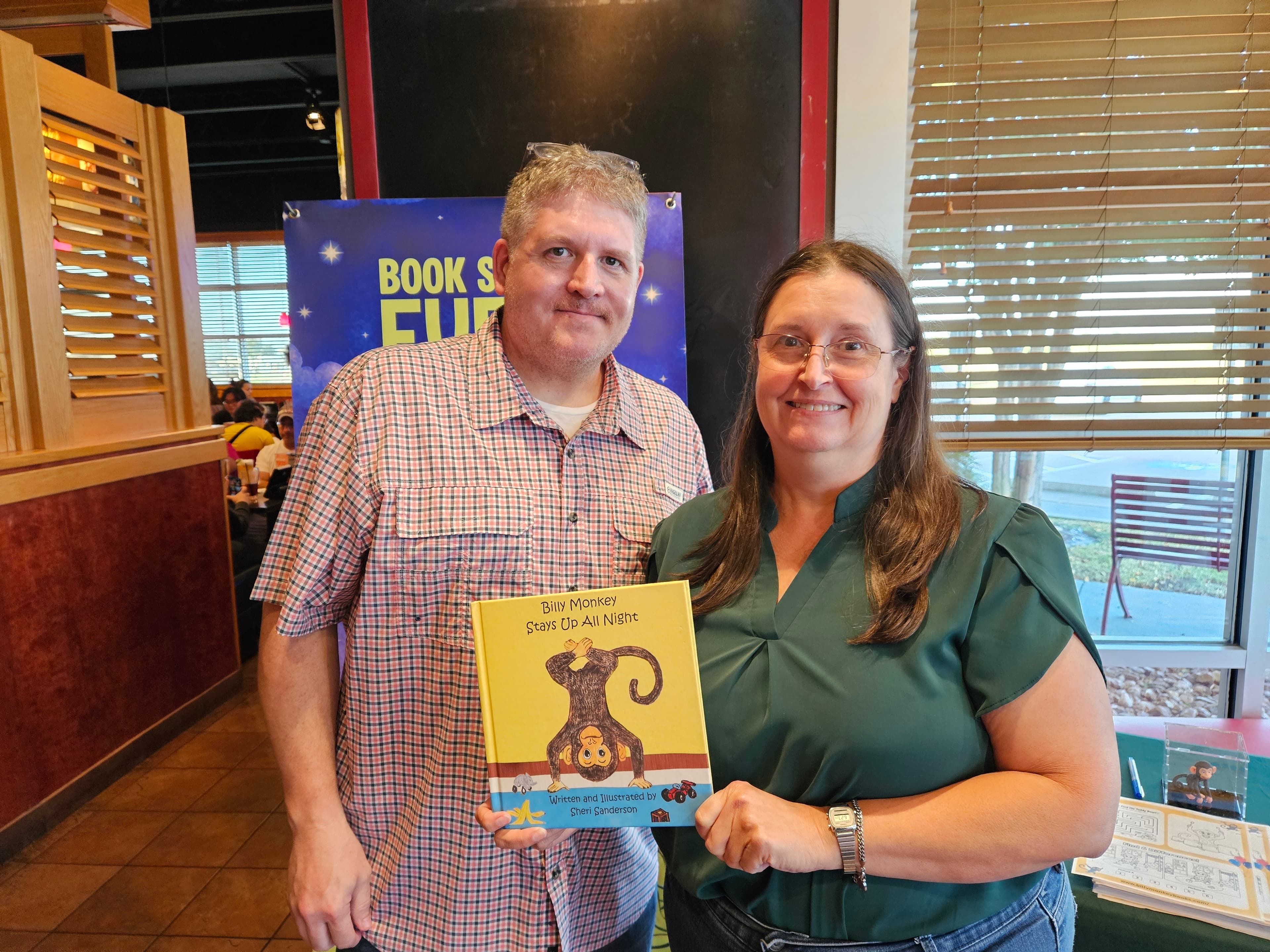 Sheri Sanderson with a happy reader holding his signed Billy Monkey book